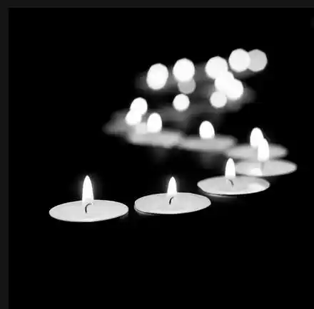 Bougies chauffe-plat allumées dans l’obscurité. Illustration de la nouvelle sur les moeurs « La Minute de Silence » d’Hervé Gransart.